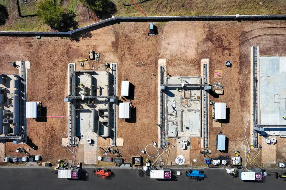 Overhead view of houses being 3d printed in concrete from the ground up.